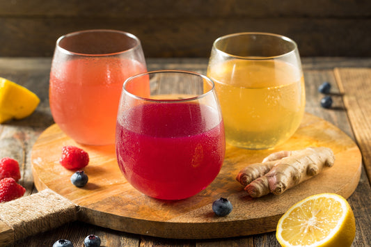 A detail photo of three different kinds of kumbucha. Does Kombucha Help with Bloating and Gas? Learn more about the probiotic truth about the fizzy fermented favorite in our complete guide.
