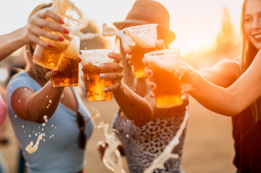 A group of friends enjoy a round of beers at an outdoor festival. Gas is among the many unpleasant symptoms of drinking beer. Learn how Shreddies can help.