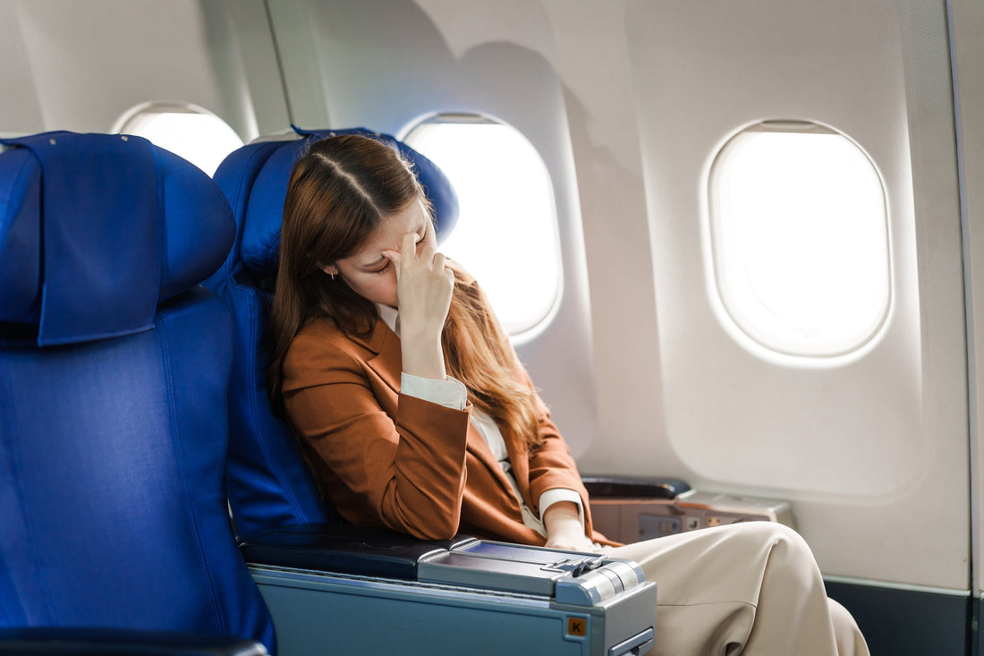 A man on a plane appears ill. Does altitude make you gassy? Yes—gas expands 25-30% at 8,000 feet due to pressure drops. Learn why planes and mountains trigger bloating and how to manage it.