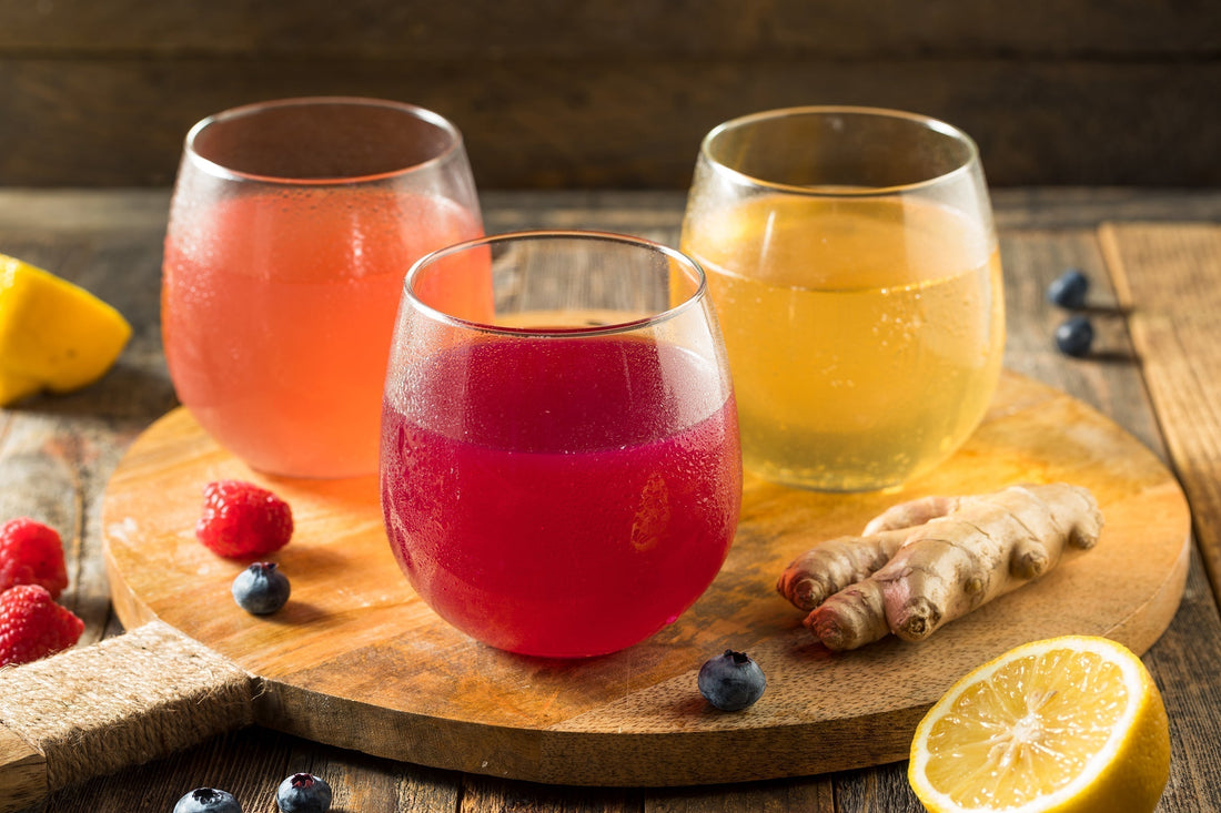 A detail photo of three different kinds of kumbucha. Does Kombucha Help with Bloating and Gas? Learn more about the probiotic truth about the fizzy fermented favorite in our complete guide.