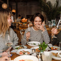 A group of friends at a restaurant. You can't always control when gas happens, but you can control how noticeable it is. See what actually helps manage gas odor in public.